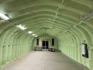 Green spray foam installed in a steel quonset hut