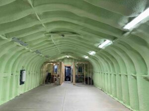 Green spray foam installed in a steel quonset hut